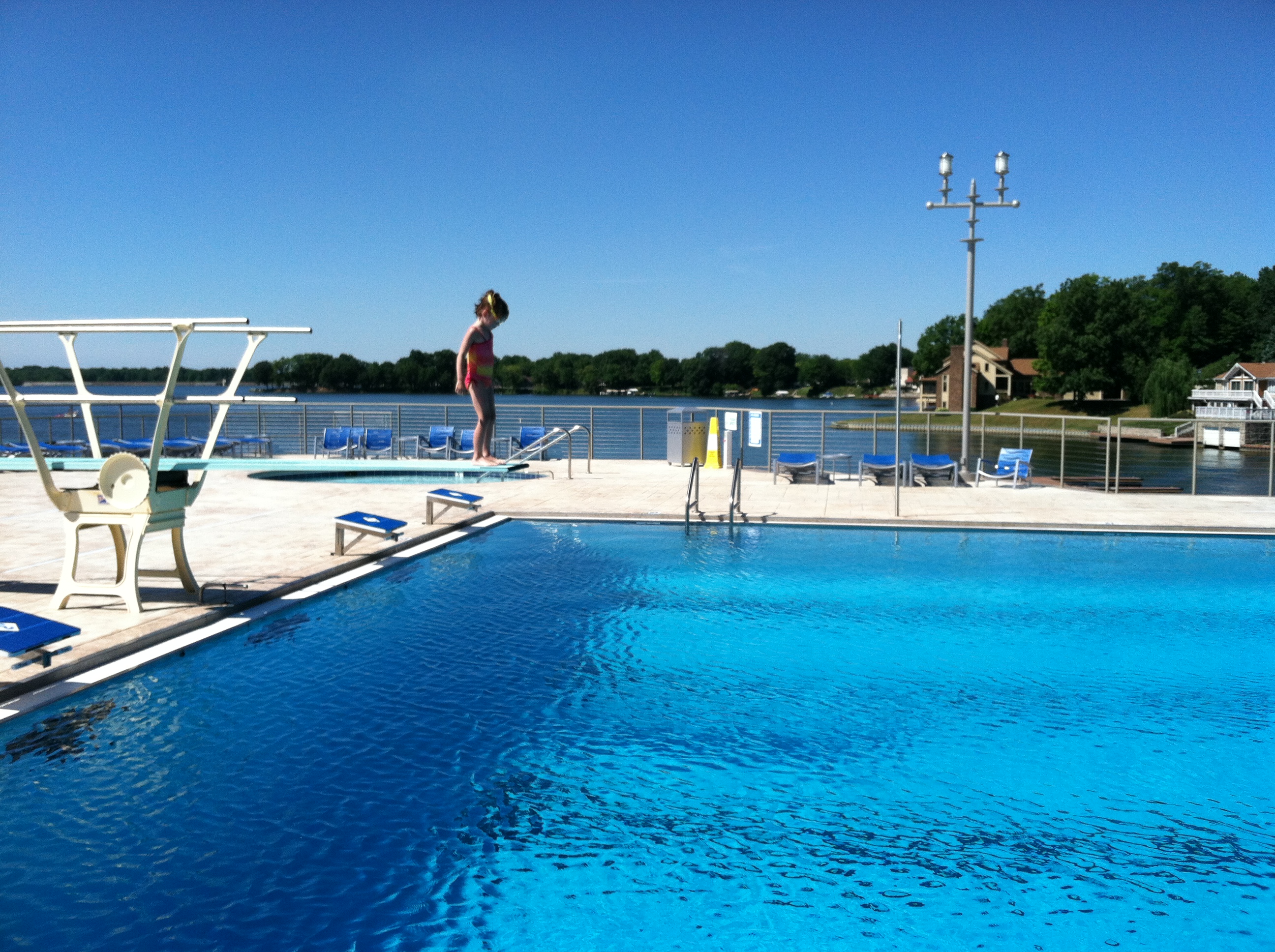 Competition size pool with diving board overlooking Morse Lake